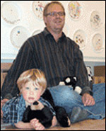photo of toddler and father sitting on floor