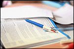 photo of workspace - books, pen, etc.